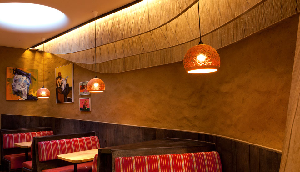 Undulated clay finish. Nando's restaurant in Falkirk, Scotland. Courtesy of Nando's and James Parsons, the photographer