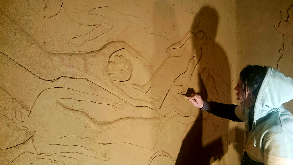 Guy Valentine carving clay wall at Hattusa Restaurant in Kent