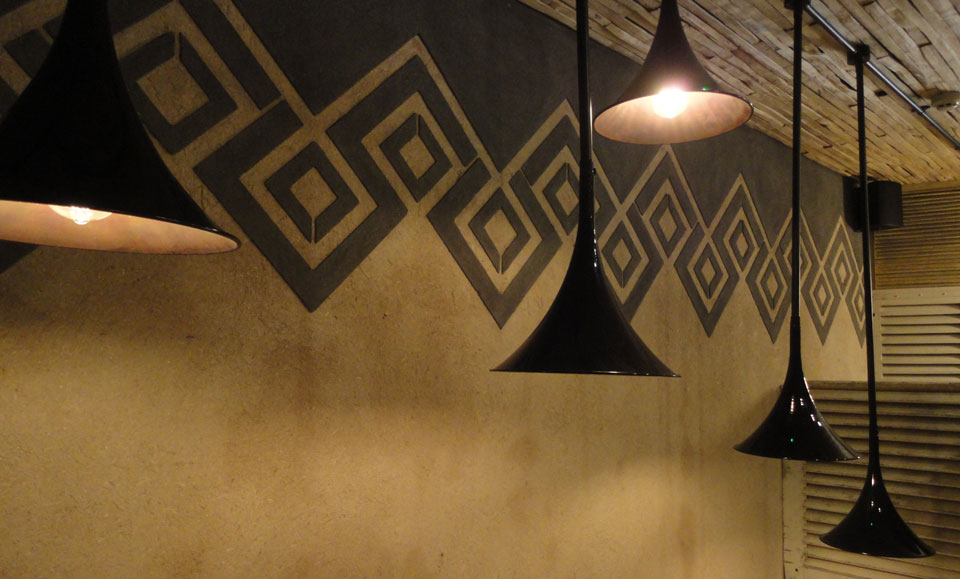 Anaglyptic two tone clay textured wall, Nando's restaurant in Glasgow