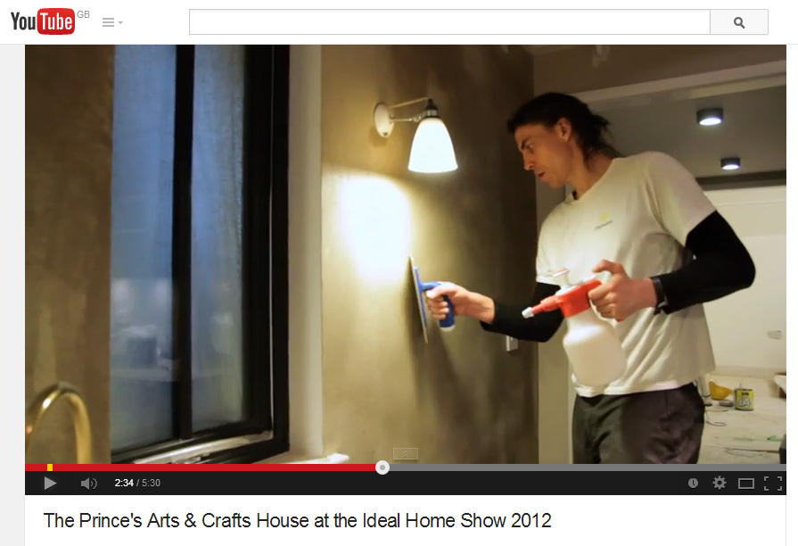 Image of Guy Valentine applying smooth top clay finish at the Prince's Arts and Crafts House, Ideal Home Show in 2012.
