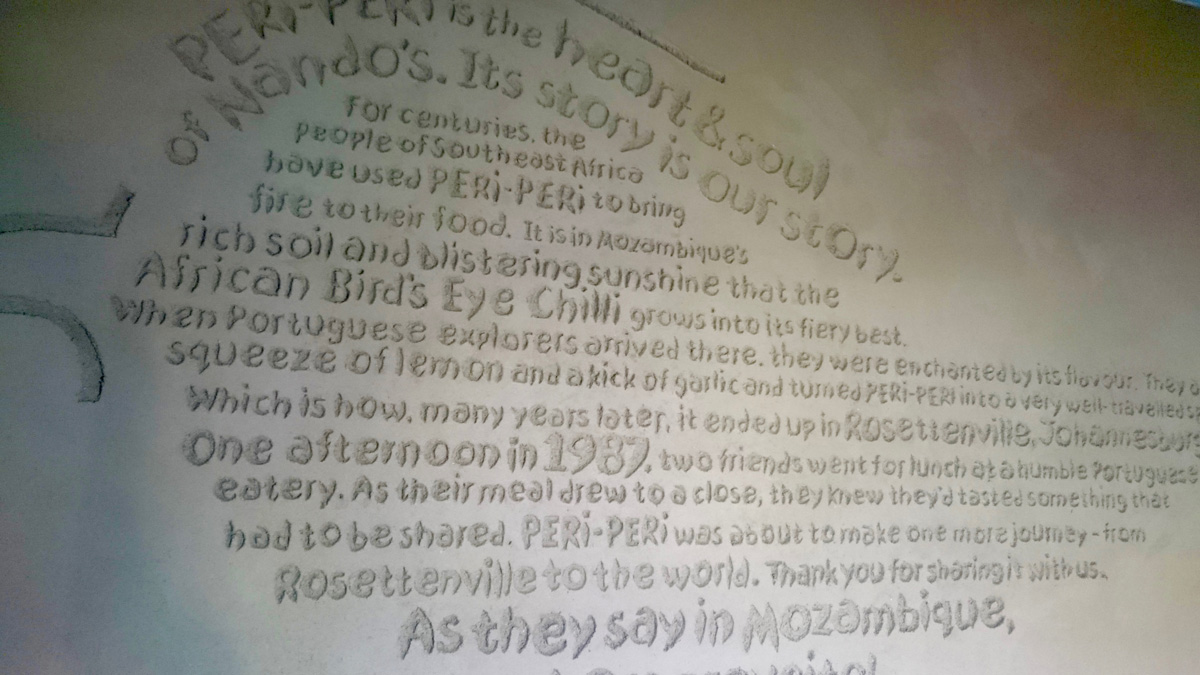 Carved clay wall by Guy Valentine at Nando's Stafford.