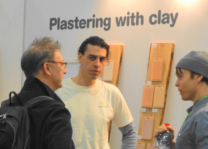 Guy Valentine (middle) and Adam Weismann (Clayworks director, right) discussing clay plastering with a potential client at the Ecobuild